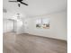 Bright living room with wood-look flooring, a modern ceiling fan and plenty of natural light at 1319 Brookside Dr, Columbus, IN 47201