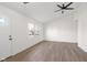 Inviting living room featuring wood-look flooring, bright ceiling fan and large windows at 1319 Brookside Dr, Columbus, IN 47201