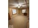 Simple bedroom featuring neutral walls, two windows, ceiling fan, and neutral carpet at 133 Tripps Ave, Lebanon, IN 46052