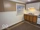 Compact kitchen featuring essential appliances, a sink, and practical cabinet storage at 133 Tripps Ave, Lebanon, IN 46052
