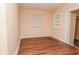 Bright empty bedroom with wood floors and a small window at 1937 N Lasalle St, Indianapolis, IN 46218