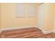 Bright empty bedroom with wood floors and two windows at 1937 N Lasalle St, Indianapolis, IN 46218