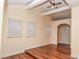 Bright living room with hardwood floors, a ceiling fan, and a doorway at 1937 N Lasalle St, Indianapolis, IN 46218