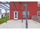 View of the back patio with pergola and hanging lights, overlooking the garden and the backdoor entrance to the home at 2016 Woodland Parks Dr, Columbus, IN 47201