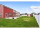 Large backyard with a concrete patio, pergola, and fresh green grass, complete with a small shed and garden at 2016 Woodland Parks Dr, Columbus, IN 47201