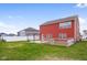 Spacious backyard featuring a concrete patio, fenced garden area, and lush green lawn, perfect for outdoor activities at 2016 Woodland Parks Dr, Columbus, IN 47201