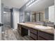The spacious bathroom features a double vanity, walk in shower, and tile flooring at 2016 Woodland Parks Dr, Columbus, IN 47201