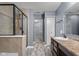 Well-lit bathroom with a glass shower, vanity, and a glimpse into a walk-in closet at 2016 Woodland Parks Dr, Columbus, IN 47201