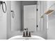 Close up of a mirror and vanity with lighting and neutral colored walls at 2016 Woodland Parks Dr, Columbus, IN 47201