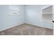 Cozy bedroom with soft carpet, two windows providing ample light, and neutral blue walls at 2016 Woodland Parks Dr, Columbus, IN 47201