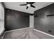 Contemporary bedroom with a ceiling fan, soft carpet, and stylish wall decor at 2016 Woodland Parks Dr, Columbus, IN 47201