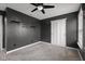 Modern gray bedroom featuring a ceiling fan, a closet, and soft carpet at 2016 Woodland Parks Dr, Columbus, IN 47201