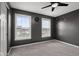 Comfortable bedroom with a ceiling fan, two windows providing natural light, and soft carpet at 2016 Woodland Parks Dr, Columbus, IN 47201