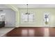 Bright dining area with hardwood floors, large windows, and a glass door leading to the outdoor patio at 2016 Woodland Parks Dr, Columbus, IN 47201