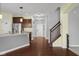 Inviting entryway and kitchen featuring hardwood floors, stainless steel appliances, and stairs at 2016 Woodland Parks Dr, Columbus, IN 47201