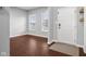 Bright foyer featuring hardwood floors, a white front door, and natural light at 2016 Woodland Parks Dr, Columbus, IN 47201