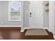 Inviting entryway featuring hardwood floors, natural light and decorative wall baskets at 2016 Woodland Parks Dr, Columbus, IN 47201