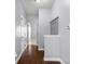 Hallway with hardwood floors, coat rack, and white trim at 2016 Woodland Parks Dr, Columbus, IN 47201