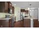 Open concept kitchen with stainless steel appliances, an island with seating, and hardwood floors. Ample cabinet space at 2016 Woodland Parks Dr, Columbus, IN 47201