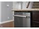 Stainless steel dishwasher set in modern kitchen with dark wood cabinets and a countertop at 2016 Woodland Parks Dr, Columbus, IN 47201