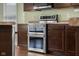 Stainless steel double oven set in modern kitchen with dark wood cabinets at 2016 Woodland Parks Dr, Columbus, IN 47201
