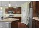 Well-equipped kitchen featuring dark cabinets, stainless steel appliances, and granite countertops at 2016 Woodland Parks Dr, Columbus, IN 47201