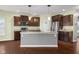 Stylish kitchen featuring dark cabinets, a central island, and stainless steel appliances at 2016 Woodland Parks Dr, Columbus, IN 47201