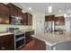 Gourmet kitchen featuring stainless steel appliances, granite countertops, and ample cabinet space, next to the pantry at 2016 Woodland Parks Dr, Columbus, IN 47201