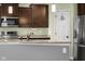 Updated kitchen with stainless steel appliances, light granite countertops, a modern faucet, and a pantry door at 2016 Woodland Parks Dr, Columbus, IN 47201