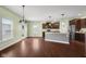 Open-concept kitchen and dining area with hardwood floors, stainless steel appliances, and ample natural light at 2016 Woodland Parks Dr, Columbus, IN 47201