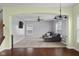 Open living room with hardwood floors, a ceiling fan, and a large window for natural light. Carpeted living area at 2016 Woodland Parks Dr, Columbus, IN 47201