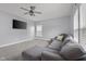 Comfortable living room with plush sofa, ceiling fan, large windows, and a wall-mounted television at 2016 Woodland Parks Dr, Columbus, IN 47201