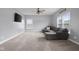 Spacious living room with carpet flooring, large windows providing natural light, plush sofa and a ceiling fan at 2016 Woodland Parks Dr, Columbus, IN 47201