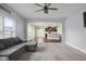Comfortable living room with open layout to kitchen, ceiling fan, and lots of natural light at 2016 Woodland Parks Dr, Columbus, IN 47201