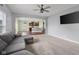 Comfortable living room with open layout to kitchen, ceiling fan, and lots of natural light at 2016 Woodland Parks Dr, Columbus, IN 47201