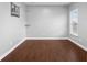 Empty room featuring hardwood floors, ample natural light, and neutral paint at 2016 Woodland Parks Dr, Columbus, IN 47201