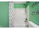 Well-lit shower-tub featuring a patterned shower curtain and wall decor, adding charm at 2016 Woodland Parks Dr, Columbus, IN 47201