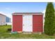 Red and white backyard storage shed, providing ample space for gardening tools and outdoor equipment at 2016 Woodland Parks Dr, Columbus, IN 47201