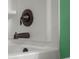 Close-up of a bronze tub faucet featuring clean white tile at 2016 Woodland Parks Dr, Columbus, IN 47201