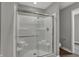 This bathroom features a tiled shower with glass doors at 2171 Mildred Rd, Westfield, IN 46074