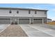 Gray townhome featuring individual garages and concrete driveways, offering modern curb appeal at 2171 Mildred Rd, Westfield, IN 46074