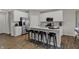 White kitchen with stainless steel appliances, a spacious island, and modern bar stools at 2171 Mildred Rd, Westfield, IN 46074
