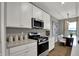 Modern kitchen with white cabinets, stainless steel appliances, and a cozy dining area at 2171 Mildred Rd, Westfield, IN 46074