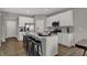 Modern white kitchen with a center island, stainless steel appliances, and bar stool seating at 2171 Mildred Rd, Westfield, IN 46074
