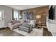 Cozy living room with a wood accent wall, comfortable seating, and a bright window at 2171 Mildred Rd, Westfield, IN 46074