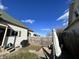 A view of the fenced backyard, and patio umbrella in the distance at 218 S 5Th Ave, Beech Grove, IN 46107
