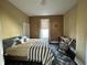 Bedroom featuring a bed, rocking chair, and natural light at 218 S 5Th Ave, Beech Grove, IN 46107