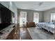 Cozy bedroom with hardwood floors, two windows, dresser and modern decor at 218 S 5Th Ave, Beech Grove, IN 46107