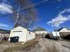 Driveway leading to detached garage and fence at 218 S 5Th Ave, Beech Grove, IN 46107