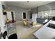 Grey and white eat-in kitchen features retro table set and lighting fixture at 218 S 5Th Ave, Beech Grove, IN 46107